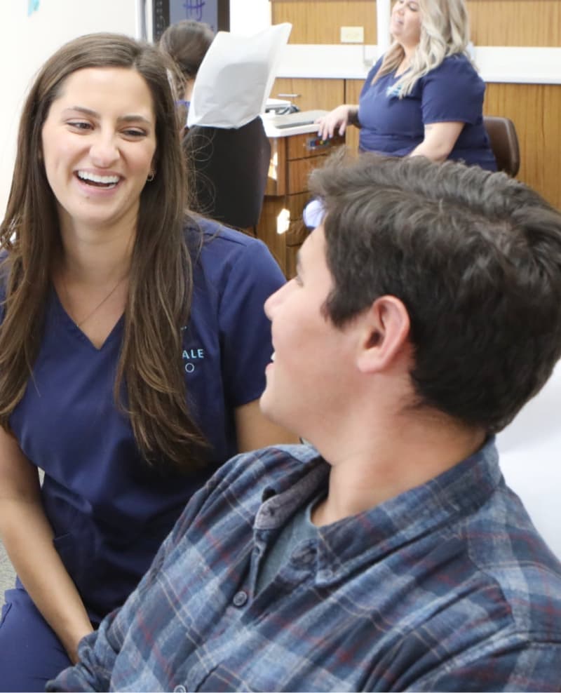 team member and patient smiling during visit
