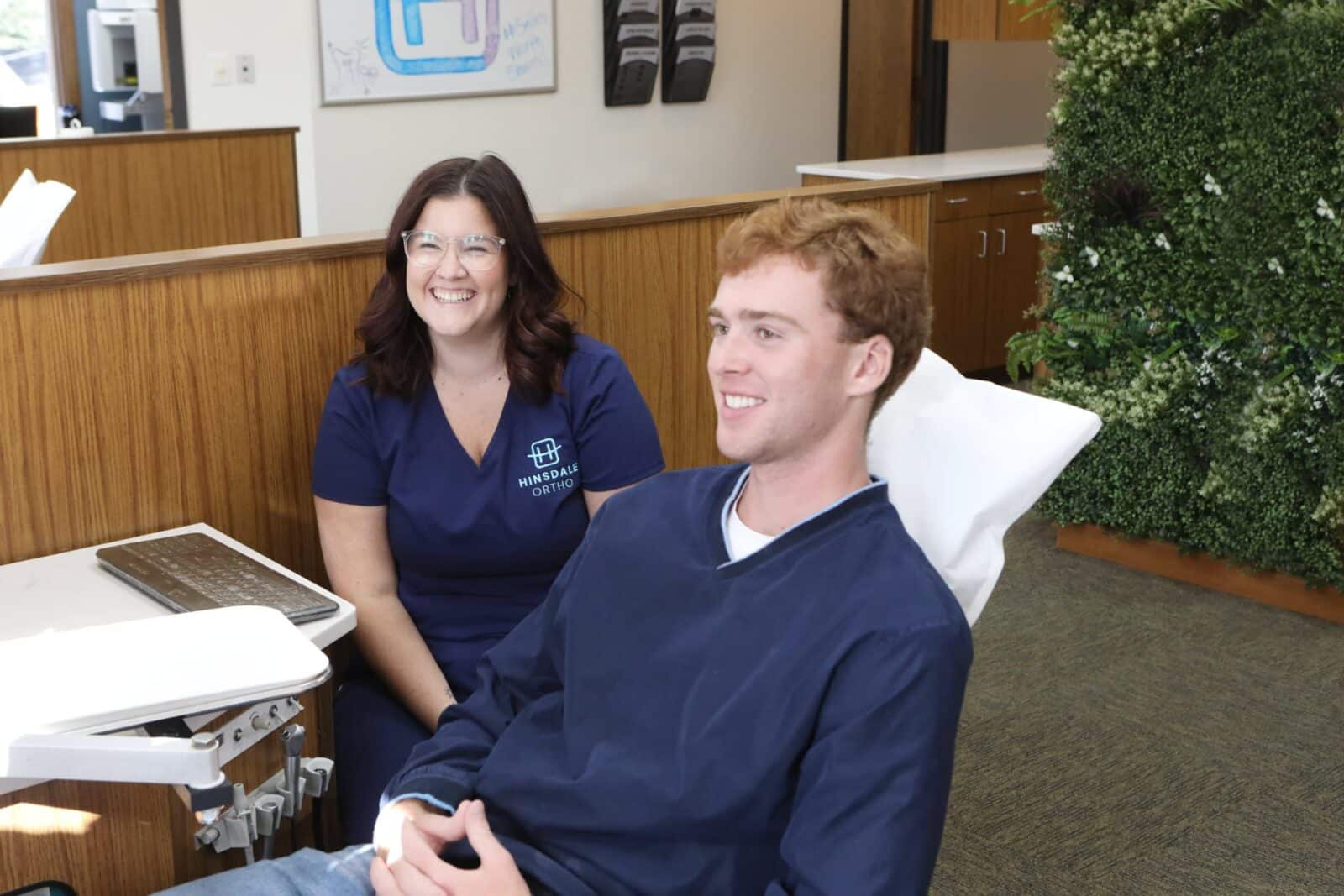 Smiling patient with orthodontic professional in Hinsdale Orthodontics office, showcasing personalized care in a welcoming environment, relevant to orthodontic treatment options in Willowbrook and surrounding areas.