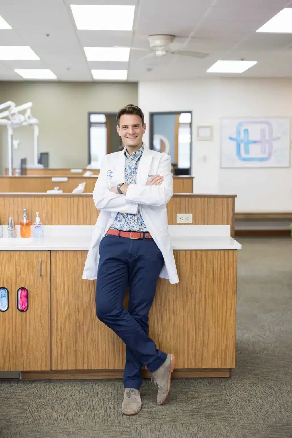 Dr. Nick Riccio, orthodontist at Hinsdale Orthodontics, smiling in a modern dental office, showcasing a patient-first approach in Brookfield, IL, emphasizing personalized orthodontic care and clear aligners.